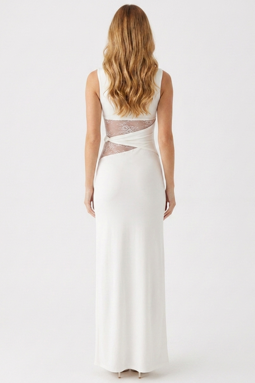 Woman wearing a white evening gown with sheer back panels on a white background